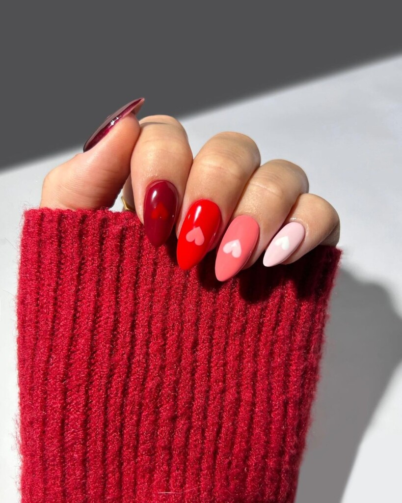 10 Valentine's Day Nail Ideas that inspire you mixture of red, pink tones with hearts on it 