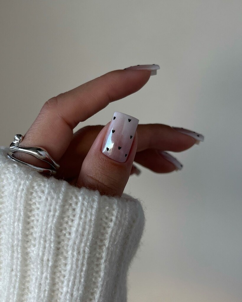 10 Valentine's Day Nail Ideas that inspire you white base with black tiny hearts