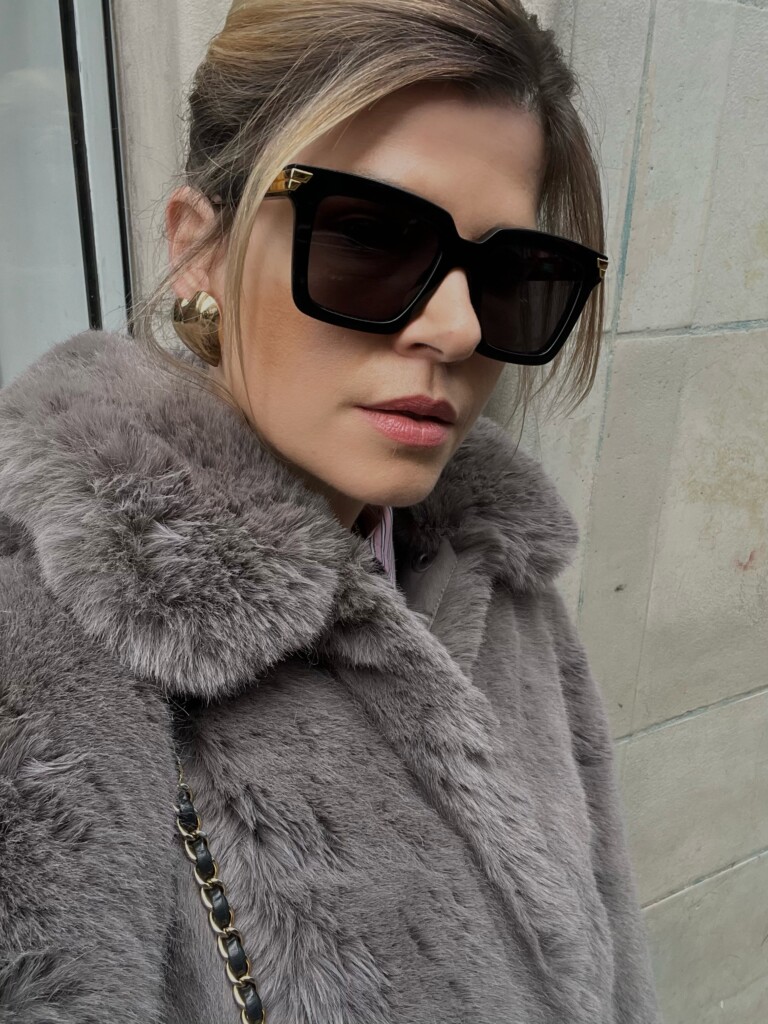 5 Sunglasses trends for 2024 Eva McMahon wearing Bottega venetta black cat eye sunglasses BV1005S