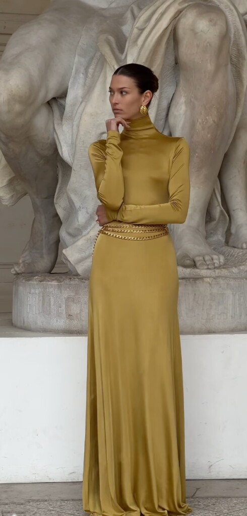 Wedding guest outfit ideas for spring summer - D Copperman wearing a mustard maxi dress with gold belt