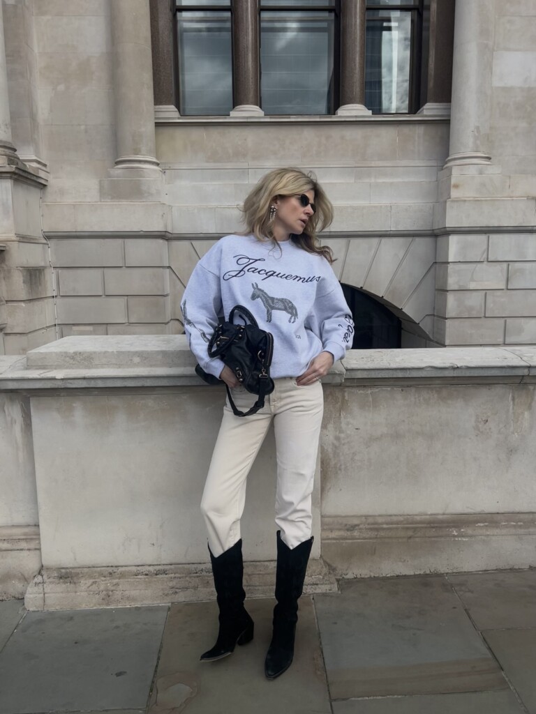 Spring 2026 Essentials: 10 Sweatshirts That Elevate Your Style Eva McMahon wearing Jacquemus sweatshirt and cowboy boots 