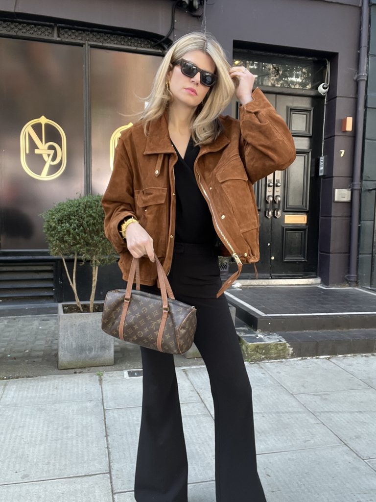Eva McMahon wearing a Suede Autumn jacket, flared black jeans and vintage Louis Vuitton papillon bag comfortable autumn outfit idea for women over 40